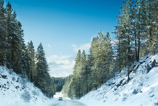Car traveling on country road on winter morning