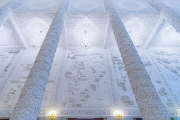 Intricate ceiling and pillars of Wat Huai Pla Kang Ubosot, Chiang Rai, Thailand