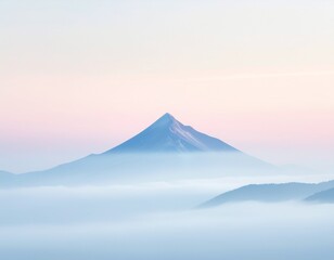 Majestic mountain peak rising above soft clouds at sunrise creates a peaceful and serene landscape scene