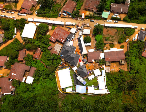 Aerial view of vibrant buildings nestled among lush greenery and bustling streets, where life unfolds in a tapestry of colors and textures, Amaolu Community, Imo State, Nigeria.