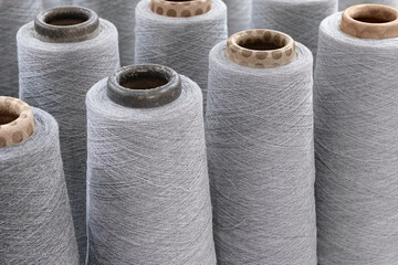 Group of large spools of thread of gray color