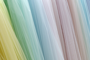 Vertical folds of translucent fabric in various pastel colors