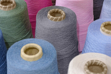 Group of large spools of thread of various colors