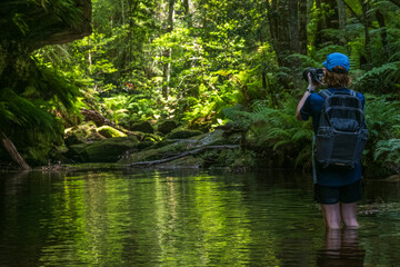 Rear view of hiker taking pictures in Grand Canyon Blackheath