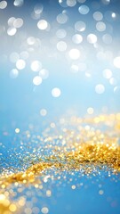 Abstract bokeh background of gold glitter on a blue surface