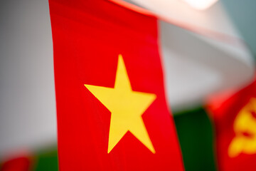 Vibrant red flag with yellow star, symbolizing national pride and identity.
