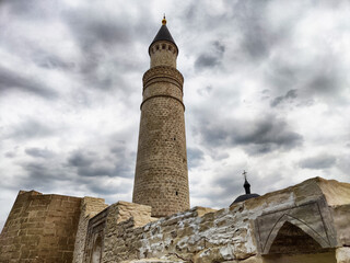 Historic minaret of Bolgar stands tall against an overcast sky in Russia highlighting ancient...