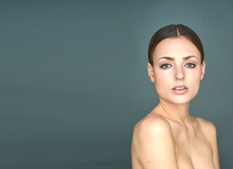 A woman with red lips and green eyes is depicted on a blue background, dressed in translucent...