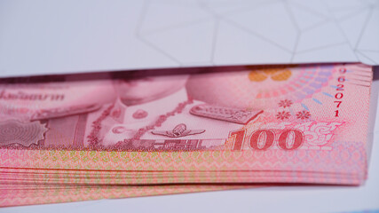 Counting different banknotes on a wooden table at a financial office