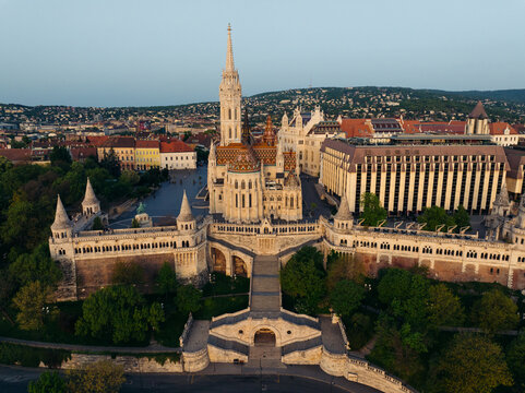 Aerial view of the Fisherman's Bastion's gleaming white stone against the backdrop of the city's terracotta rooftops and the Danube's soft blue, Budapest, Budapest, Hungary.