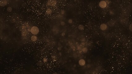 Luxury background with glittering shiny gold particles and shimmering bokeh light spheres. Elegant golden background ideal for glamorous events, award ceremonies or talent shows. 