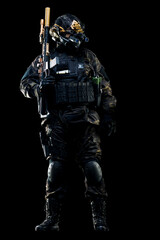 Special forces soldier in tactical gear holding weapon at the ready