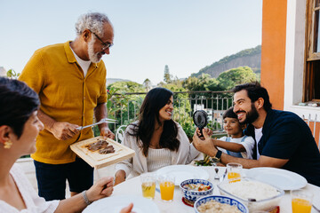 Family enjoying Brazilian churrasco with outdoor dining and laughter