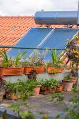 Water boiler with solar panels on roof of house in village of Madeira. High quality photo