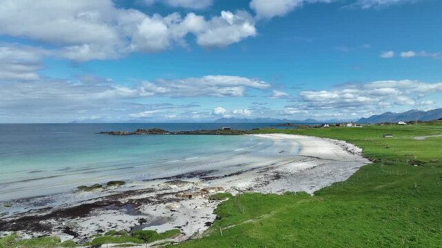 Flyover above Hov Beach on Gimsoy island, Lofoten, Norway, low over grassy area, sand, towards ocean.