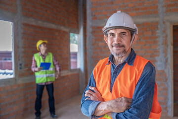 portrait senior expertise engineer standing crossed arms at construction site