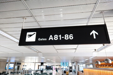 Info sign directing people to gates 81 to 86 inside international airport