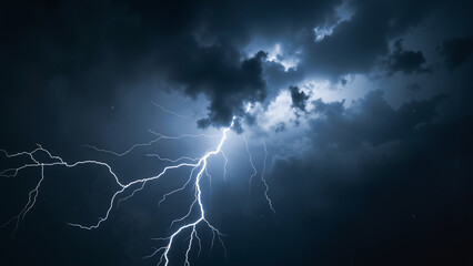 Thunderstorm with lightning bolts against dark clouds at night  