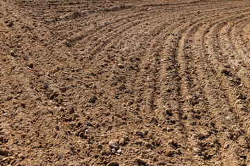 plowed soil, a field after harvest, a large field where agricultural activity is carried out in Europe