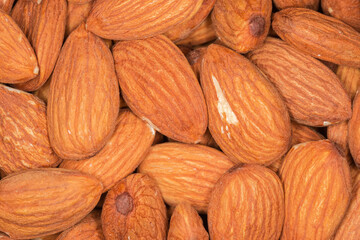 Heap of shelled almonds, top view close-up