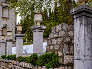 Stone vases on columns in the park.