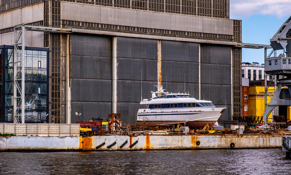 Repair of a motor yacht at the pier in the seaport. - Powered by Adobe