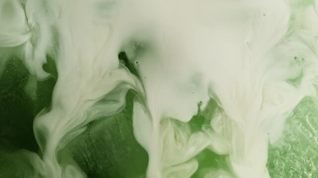 Super Slow Motion Detail Shot of Pouring Cream into Matcha Latte at 1000fps.
