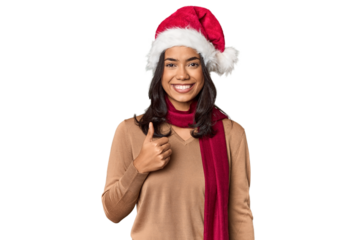 Filipino in Christmas attire and Santa hat smiling and raising thumb up
