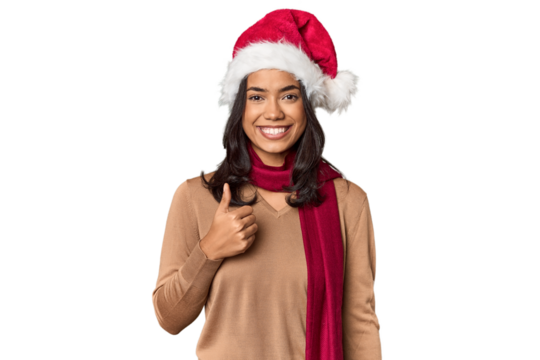 Filipino in Christmas attire and Santa hat smiling and raising thumb up