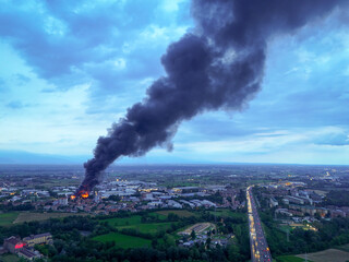 Pianezza, Italy - 04 September 2025: Aerial view of a dark plume rising high above the Euro Stamp plant, contrasting sharply against the twilight sky.