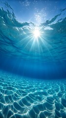 Sunlight streams through clear ocean water onto sandy seabed, creating mesmerizing light patterns