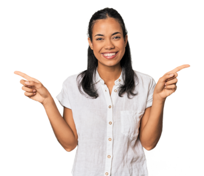 Young Filipina woman pointing to different copy spaces, choosing one of them, showing with finger.