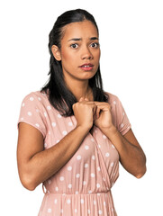 Young Filipino woman in studio scared and afraid.