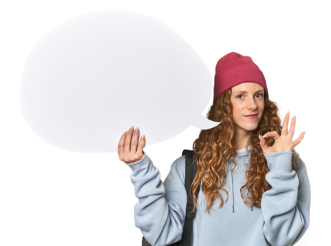 Redhead holding a comic speech bubble cheerful and confident showing ok gesture.