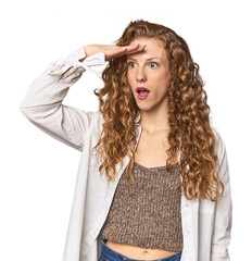 Simple redhead studio portrait looking far away keeping hand on forehead.