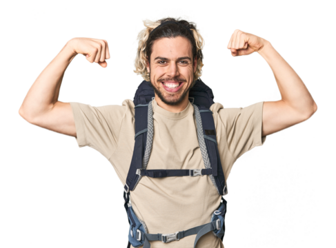 Young Caucasian hiker with backpack showing strength gesture with arms, symbol of feminine power