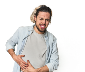 Young Caucasian man in studio setting having a liver pain, stomach ache.