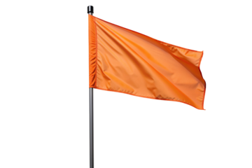 Bright orange flag waving prominently on a flagpole against a plain black background image stock photo