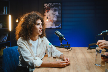 Content creator recording podcast in modern studio with colleague