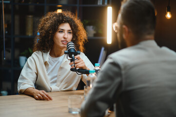 Two content creators recording podcast in home studio