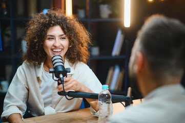 Two content creators recording podcast in modern studio