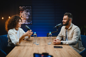 Podcasters recording audio content in modern studio