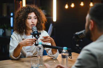 Podcasters recording audio content in modern studio