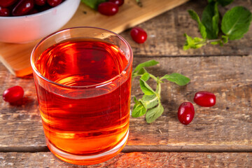 Cornelian cherry, dogwoods edible berry juice or liquor in glass