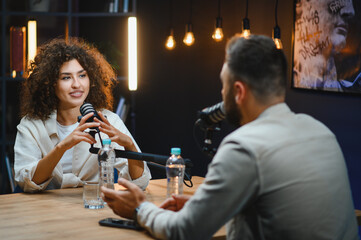 Podcasters recording audio content in professional studio