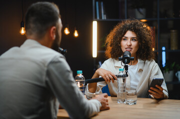 Content creators recording podcast in modern studio