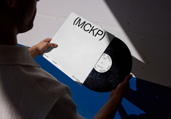 Mockup Of Man Holding Customizable Vinyl Record And Sleeve