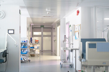 Empty hospital corridor with medical equipment and supplies waiting for patients