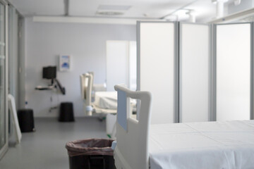 Empty hospital beds waiting for patients in modern hospital room