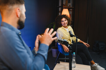 Two content creators recording podcast in home studio